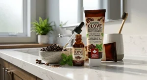 Whole cloves, clove essential oil in a dropper bottle, and natural toothpaste formulated for tooth sensitivity relief.